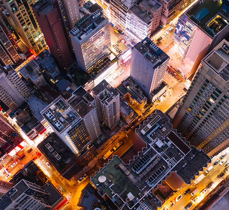 Aerial top view of downtown district buildings in night city light